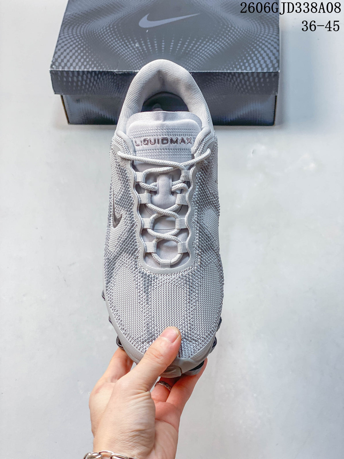 Top view of a light grey Nike Air Liquid Max sneaker with lace-up closure