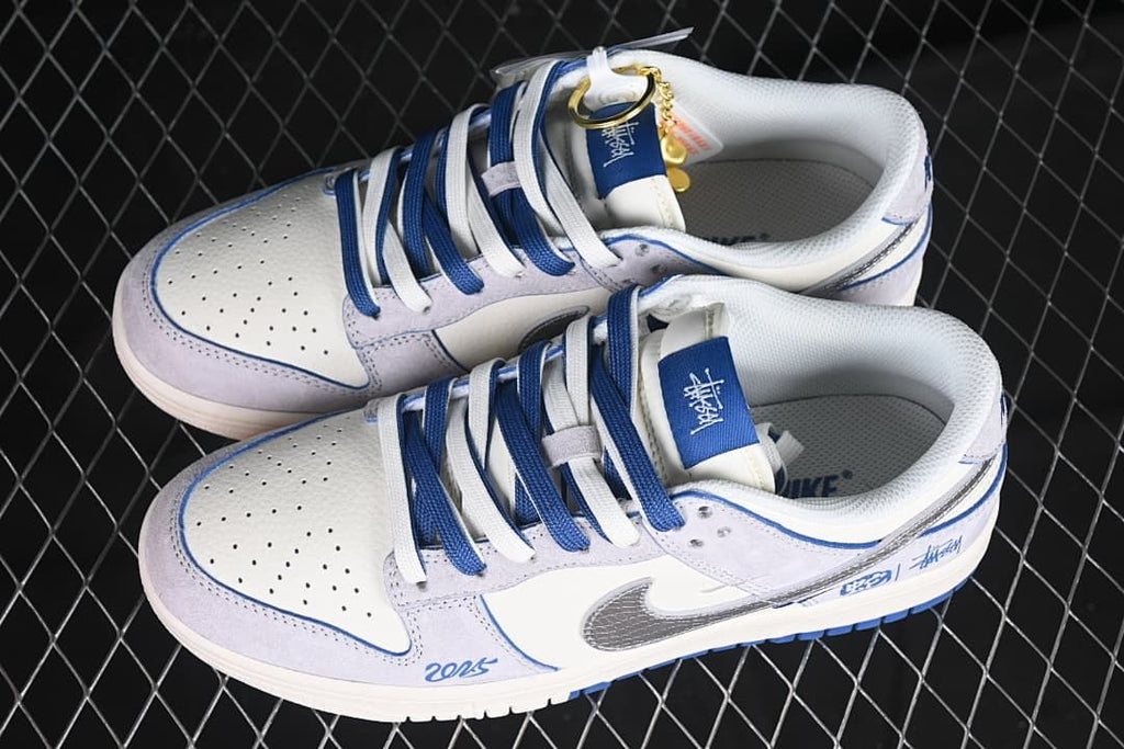 Pair of white, pale gray, blue, and silver low-top sneakers shown from above