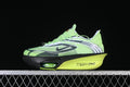 Side view of bright green Nike racing shoes with black and white accents