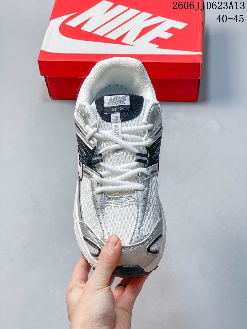 Front view of the Nike Air Max Moto 2K sneaker with white laces and silver overlays