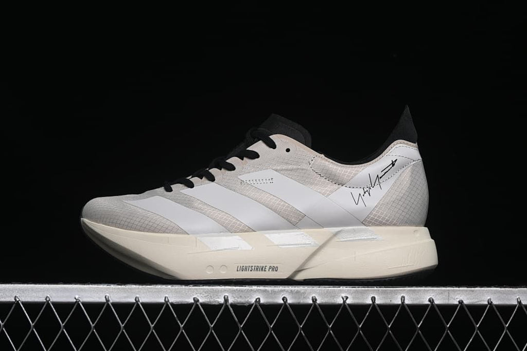 Side view of a single shoe showing the Y-3 signature detail and off-white sole