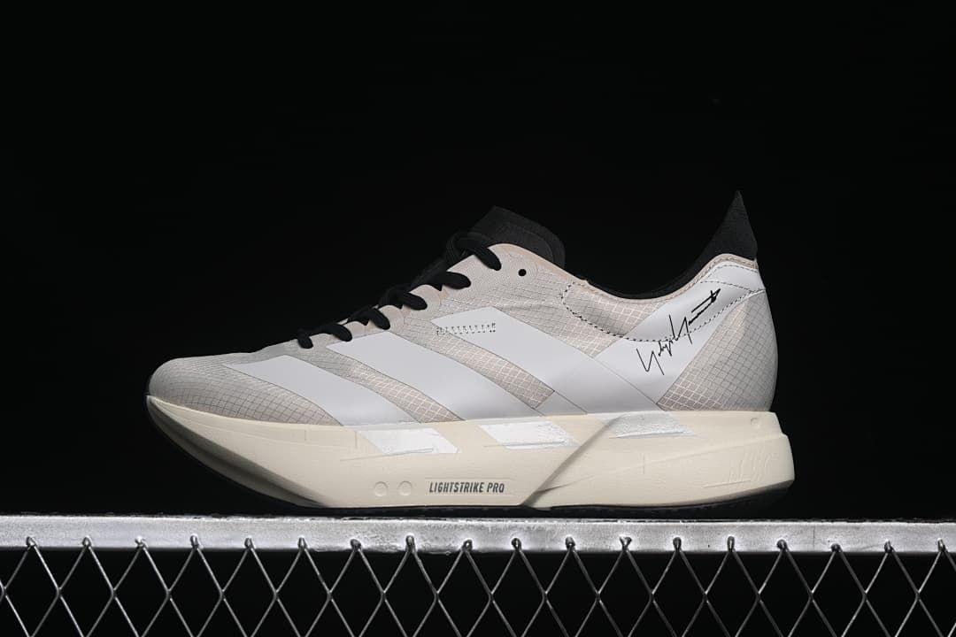 Side view of a single shoe showing the Y-3 signature detail and off-white sole