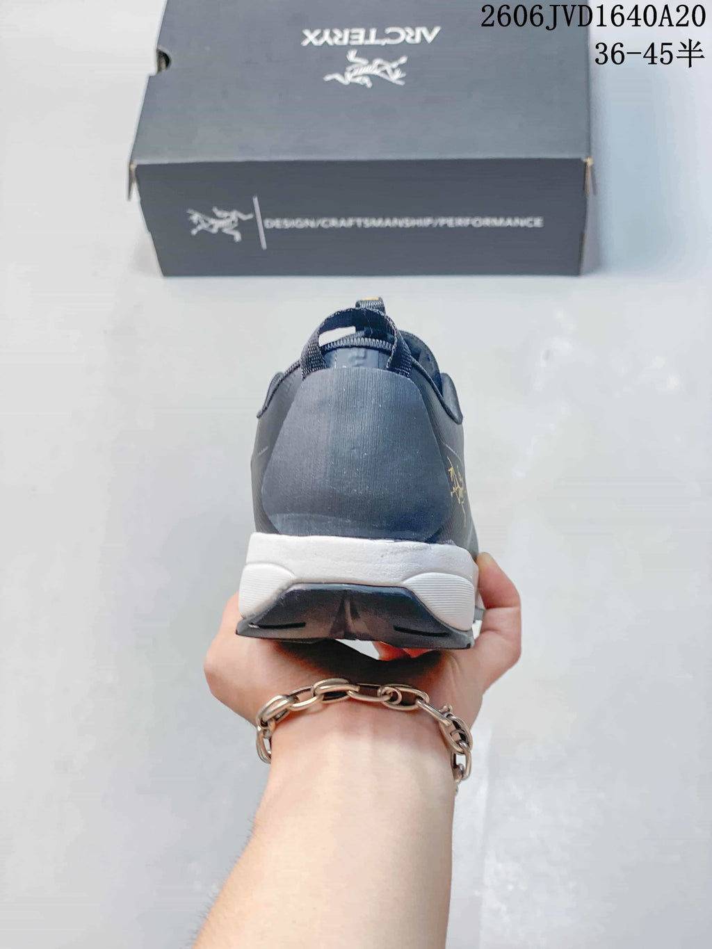 Rear view of the gray trail shoe showing the heel and midsole