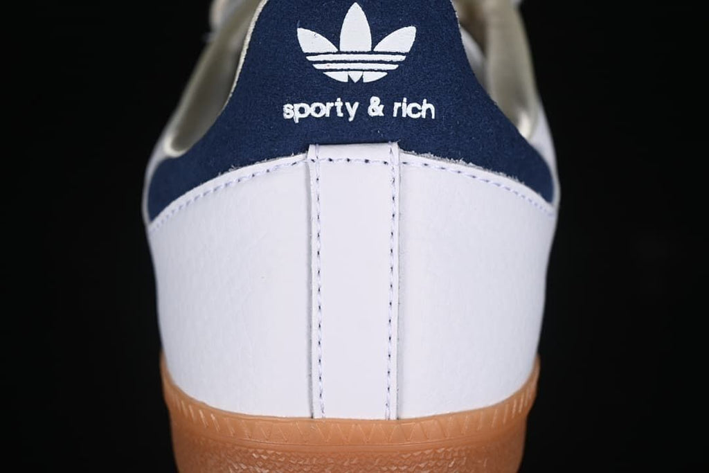 Rear view showing the navy heel tab with adidas Trefoil and Sporty & Rich branding