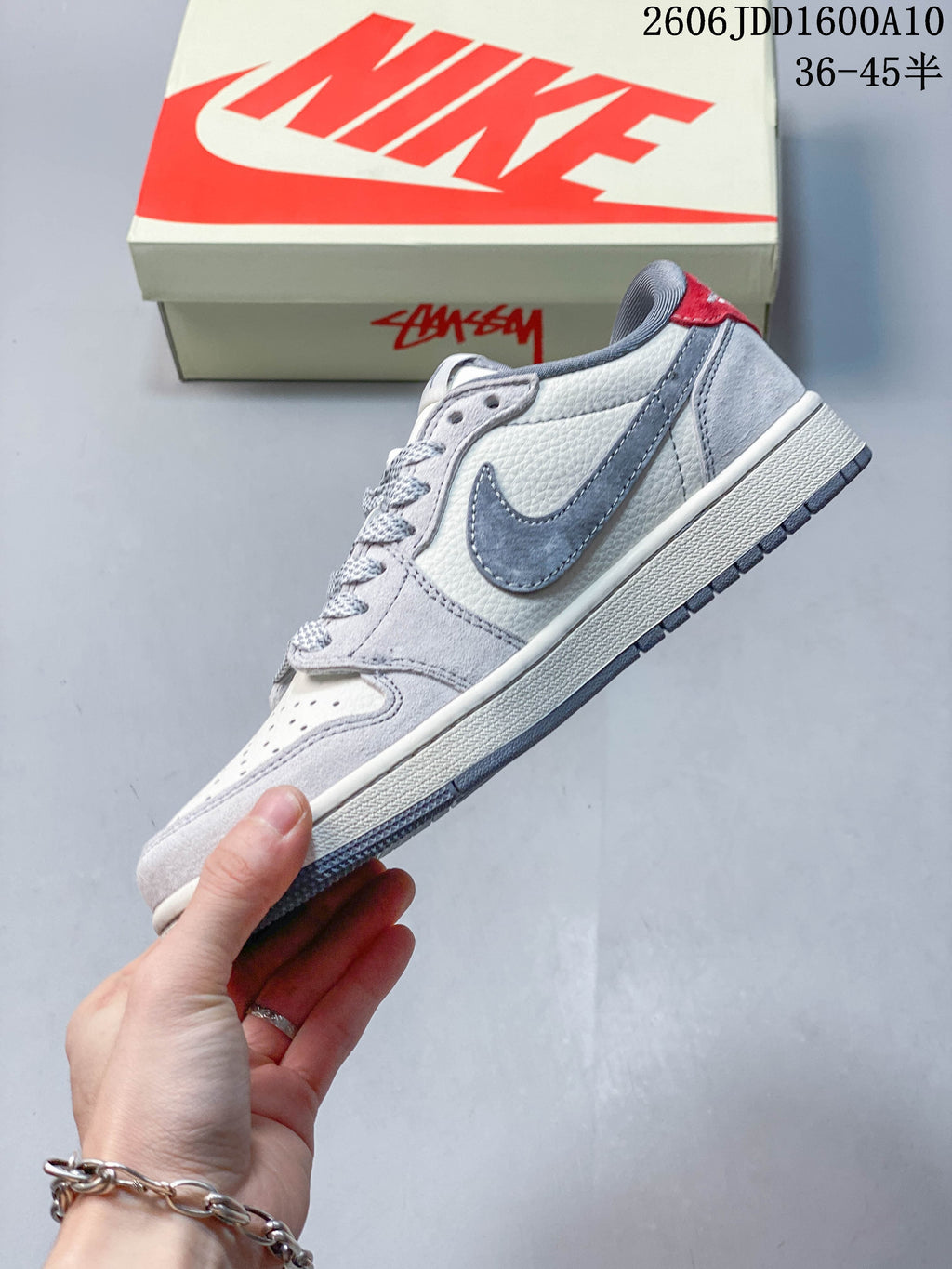 Side view showing grey overlays, a grey side panel, and red heel accent.