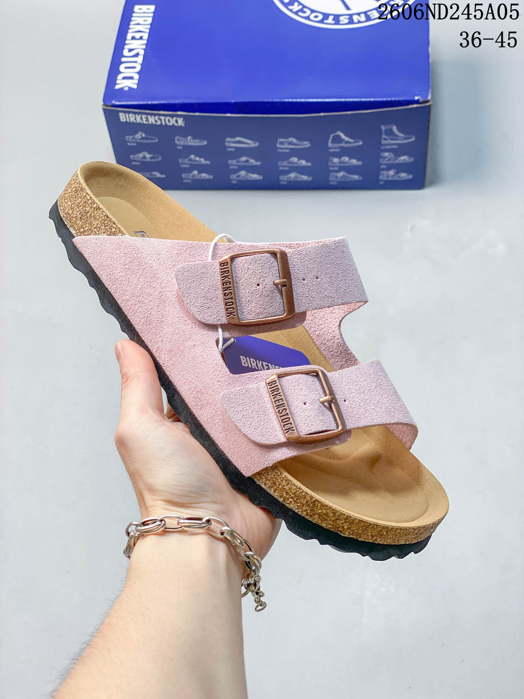 Light pink two-strap sandal with buckle closures.