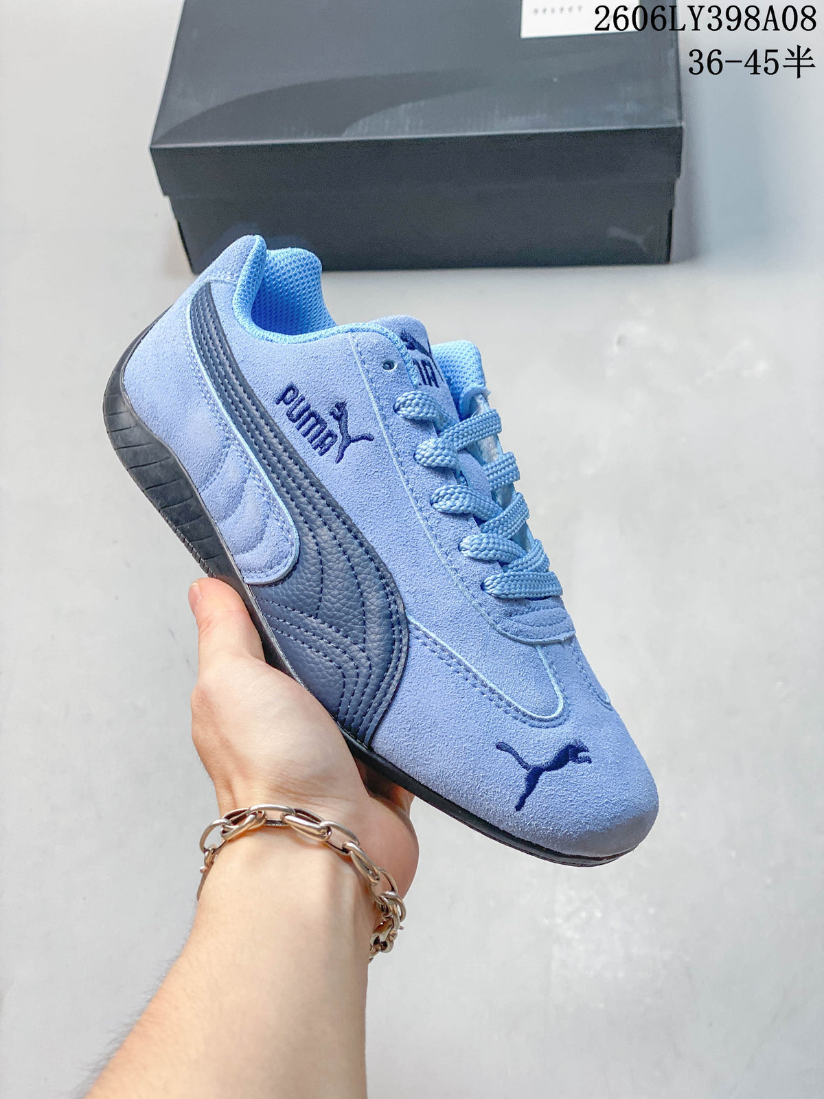 Close-up of a light blue PUMA Speedcat OG sneaker with dark side stripe