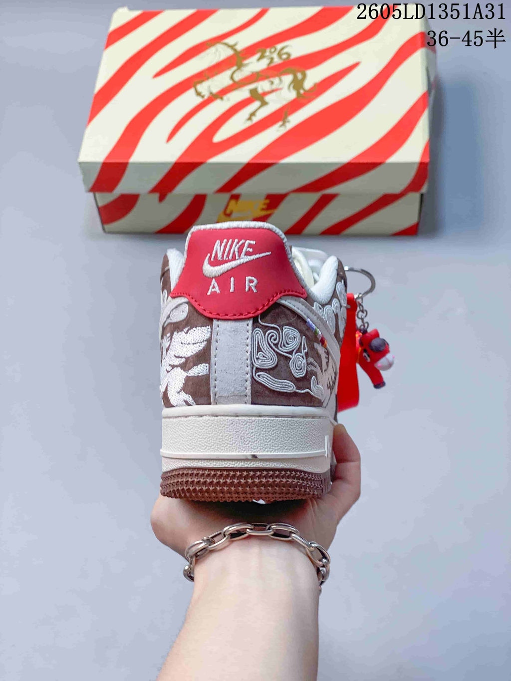 Rear view of the sneaker showing embroidered heel panels and a red heel tab.
