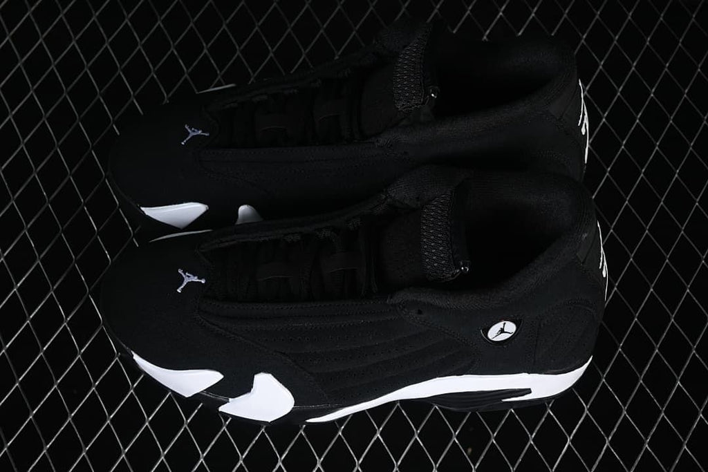 Pair of black and white Air Jordan 14 Retro sneakers
