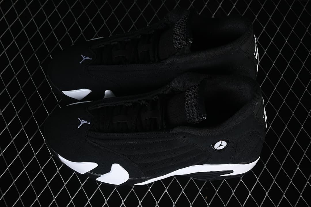 Pair of black and white Air Jordan 14 Retro sneakers