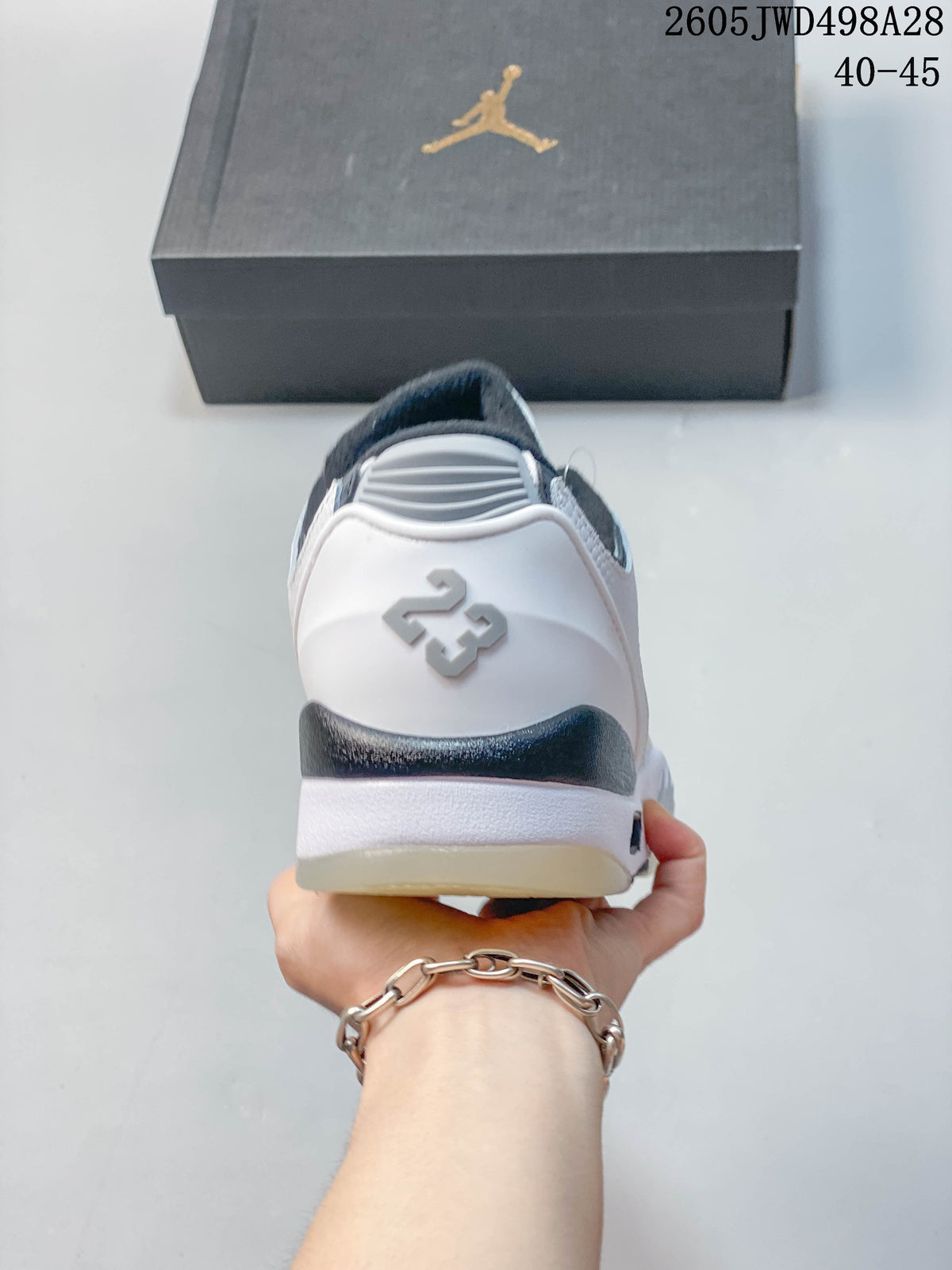 Rear view of the white sneaker showing the raised 23 detail and dark collar trim.