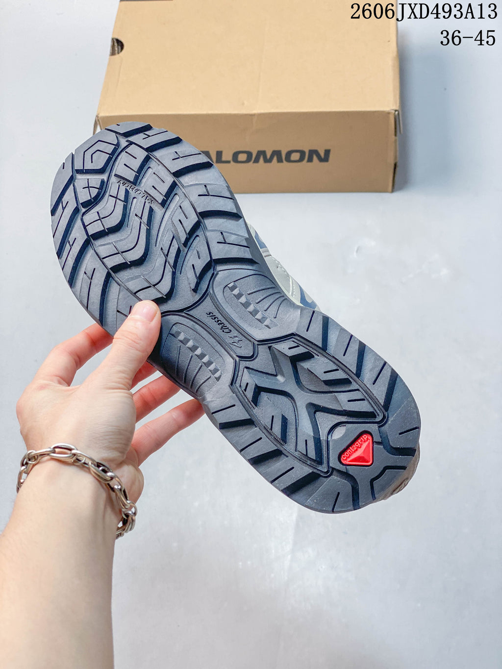 Close-up of the shoe outsole showing a dark lugged tread pattern.