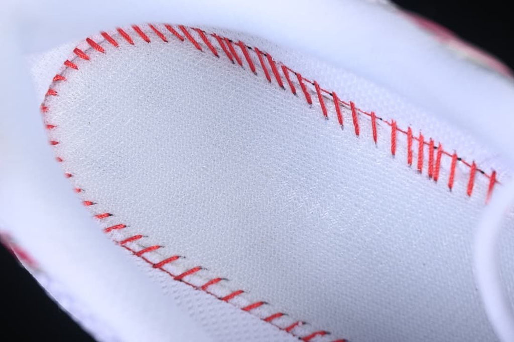 Close-up of stitching on the sneaker's white lining.