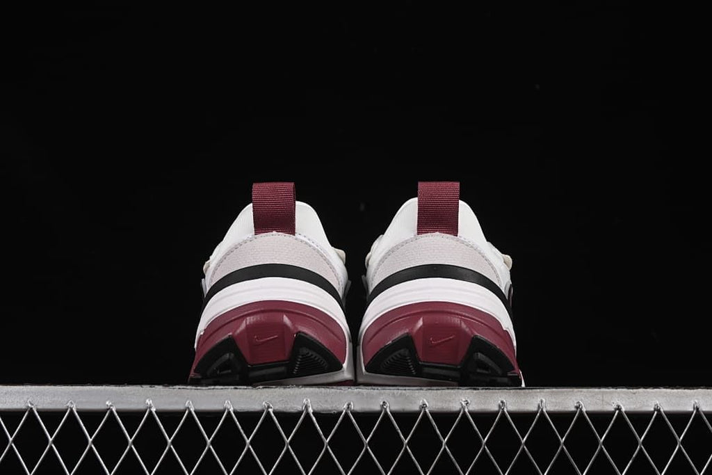 Rear view of the pair showing burgundy heel outsole sections