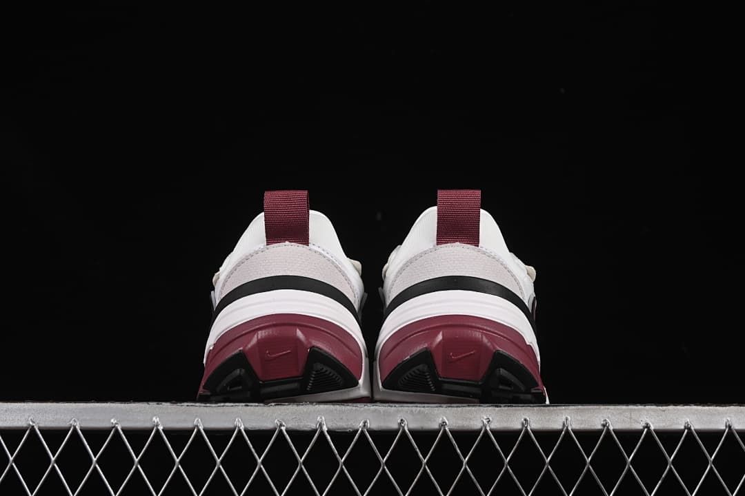 Rear view of the pair showing burgundy heel outsole sections