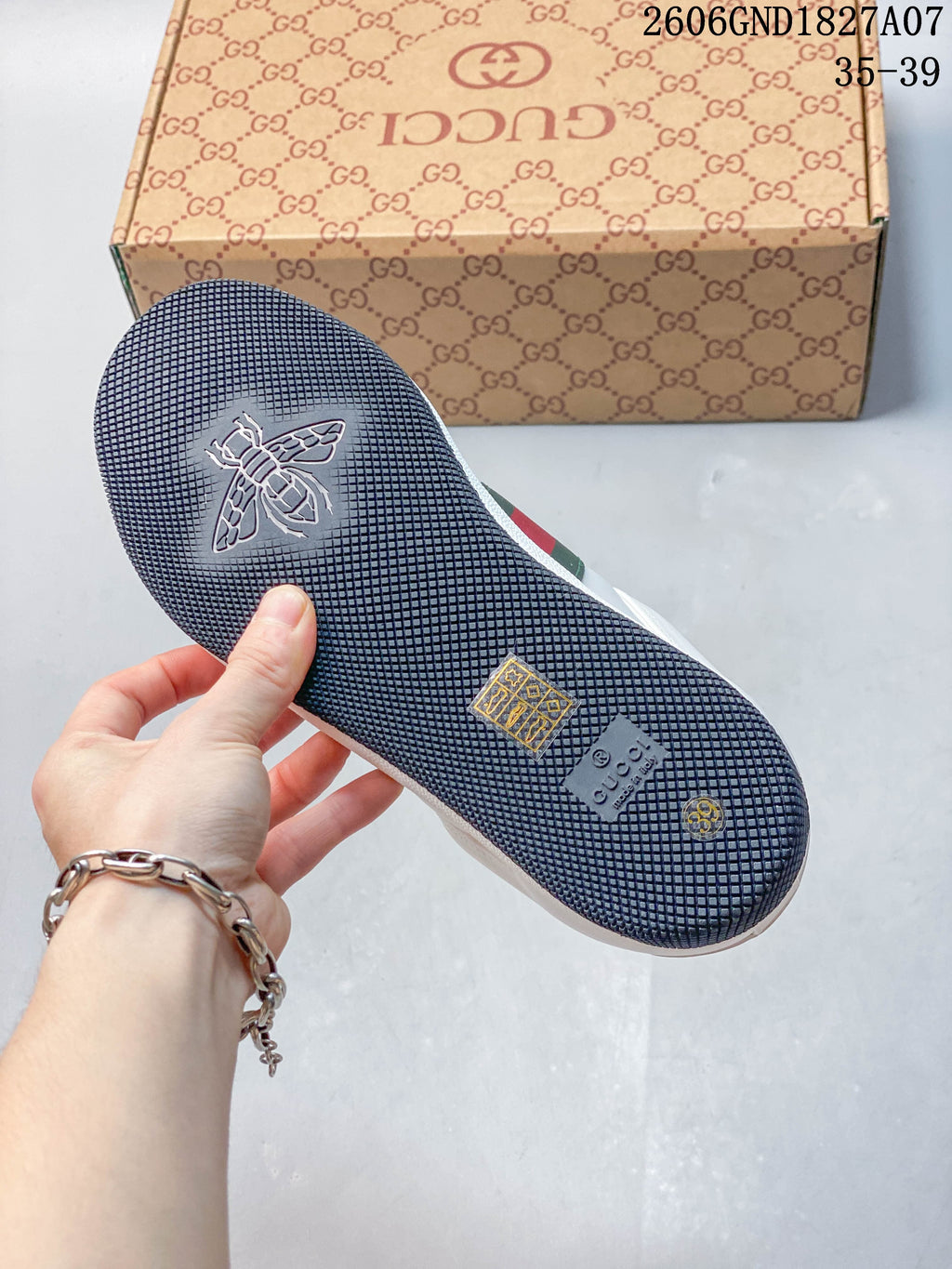 Close view of the dark textured outsole with embossed details.
