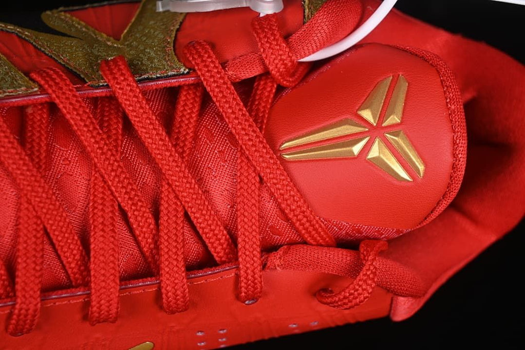 Close-up of the gold Kobe emblem on the red tongue