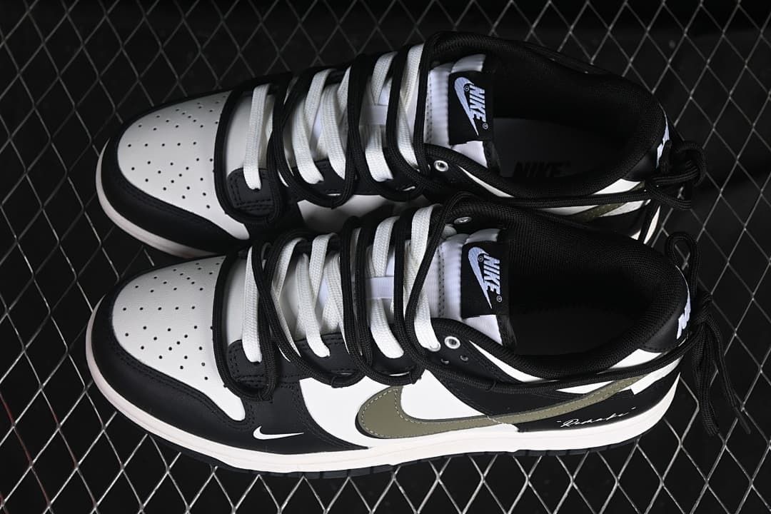 Top view of a pair of black and white Nike SB Dunk Low sneakers with contrasting laces and olive Swooshes