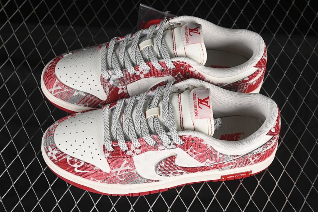 Overhead view of a pair of red and gray patterned Nike SB Dunk Low sneakers with gray laces and perforated toe boxes.