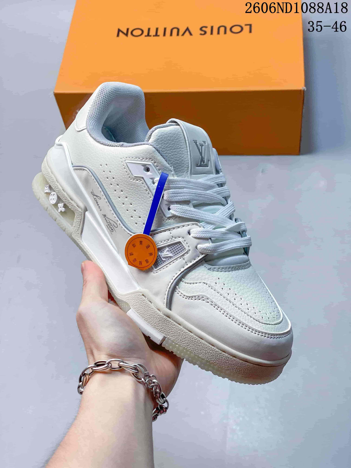 Angled view of a white Louis Vuitton Trainer sneaker with side detailing