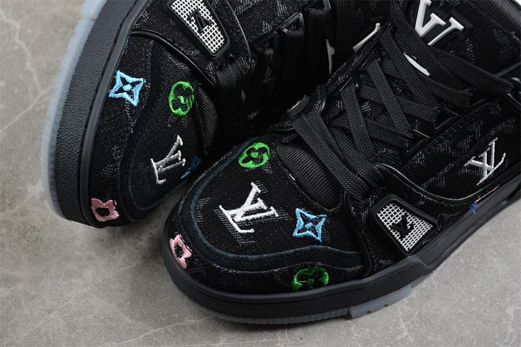 Close-up of colorful decorative motifs on the black sneaker toe and upper