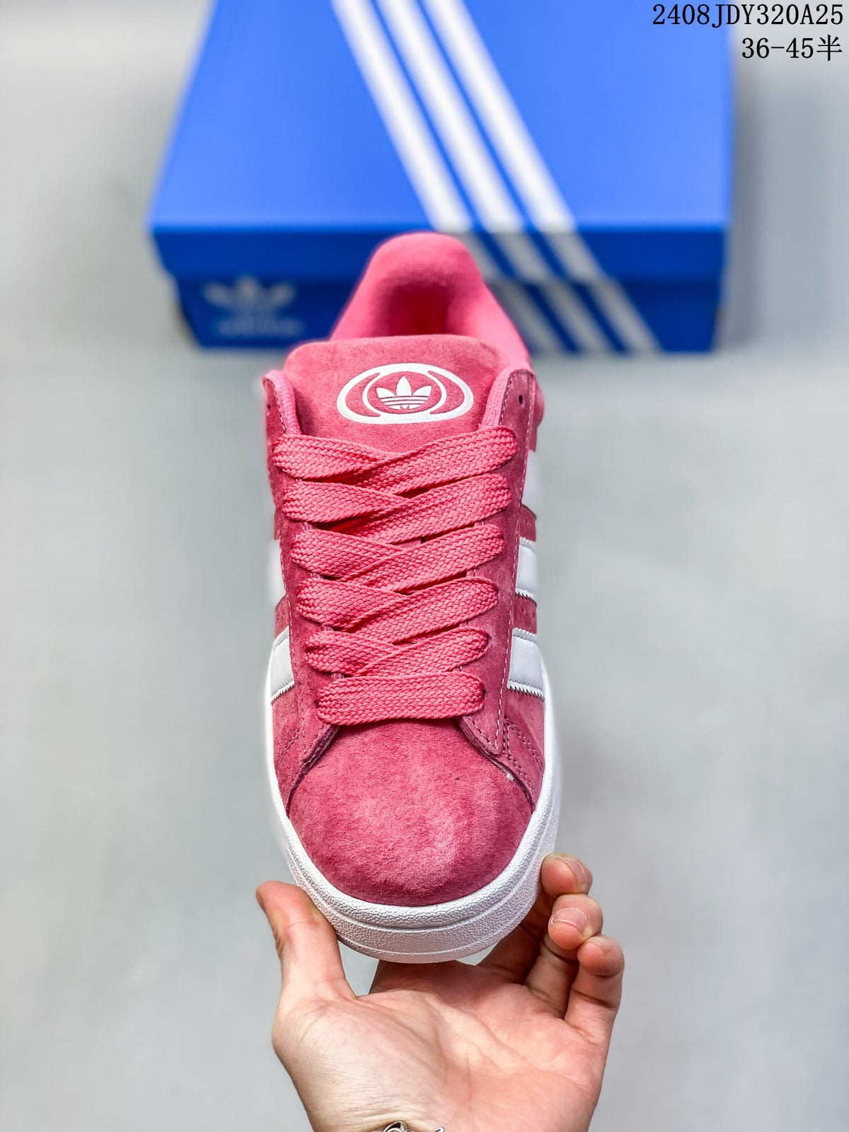 Front view of a pink lace-up sneaker with wide laces and white side stripes.