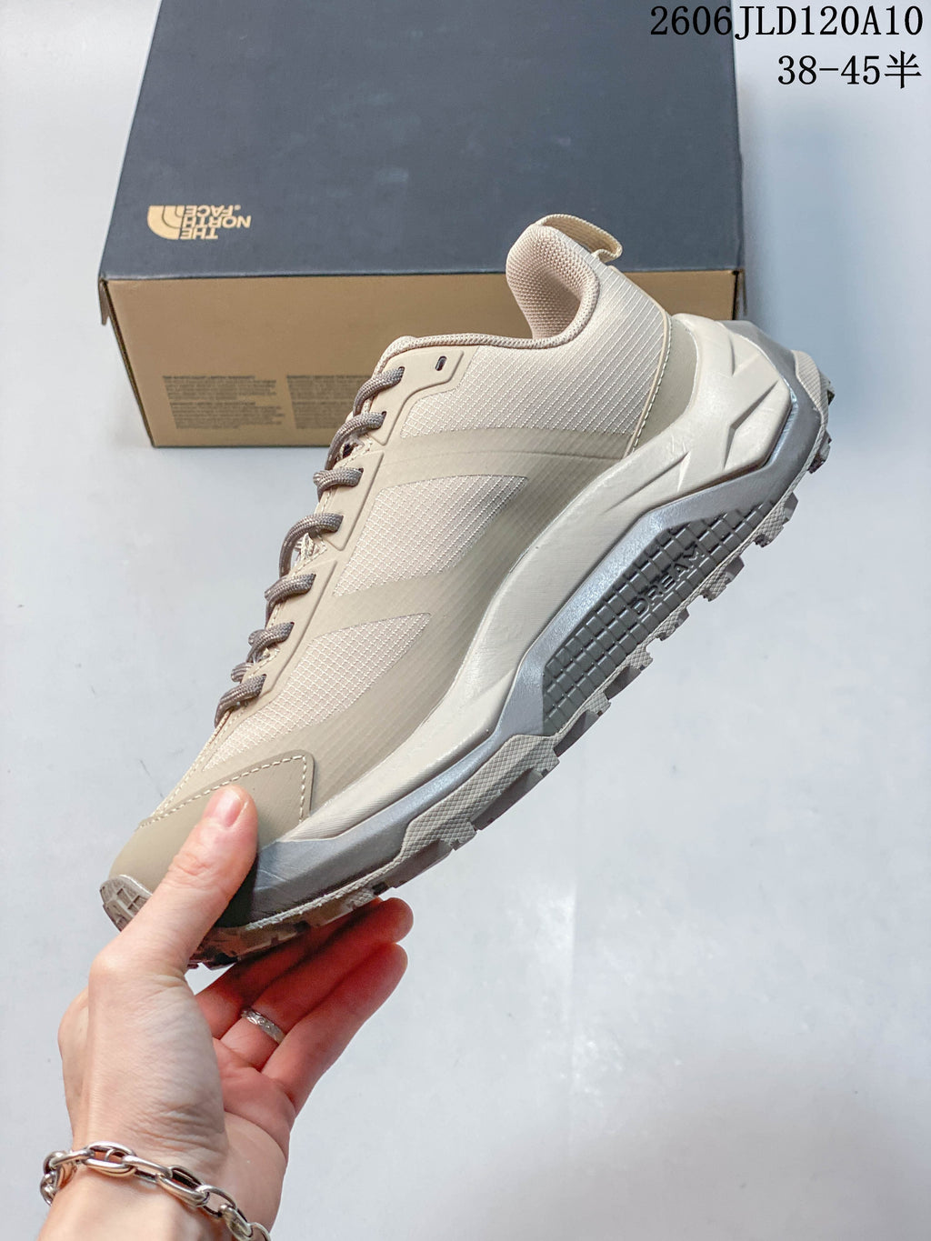 Side profile of a beige low-top outdoor shoe