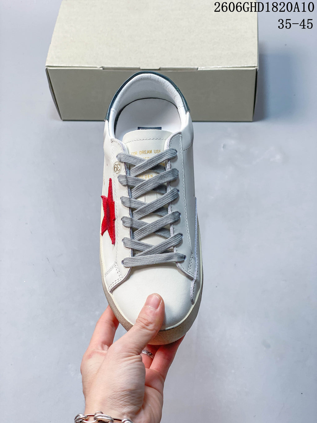 Top view of the sneaker showing gray laces and a red star detail.