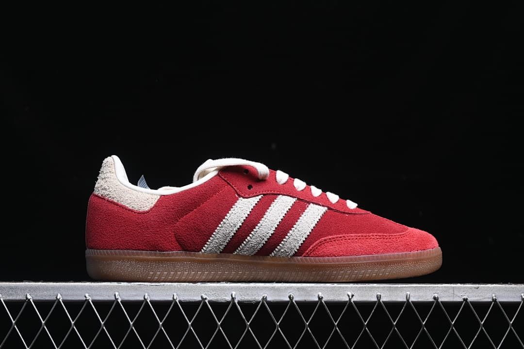 Side profile showing the red upper, off-white stripes, and gum-colored outsole.