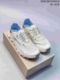 Pair of light-colored On Cloud 6 Coast sneakers displayed on a shoe box
