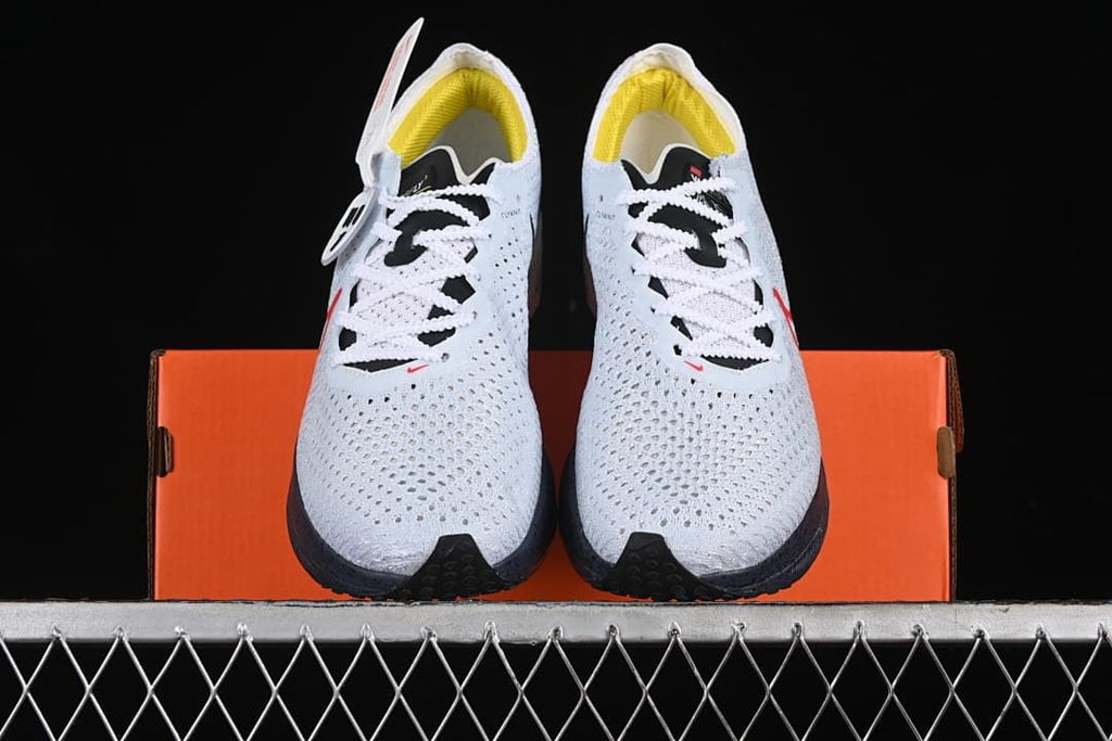 Front view of the pair showing the perforated uppers, laces, and yellow lining