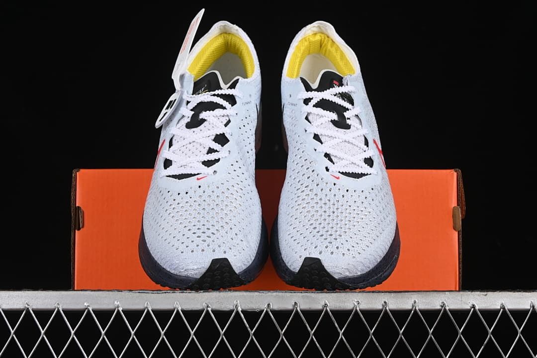 Front view of the pair showing the perforated uppers, laces, and yellow lining