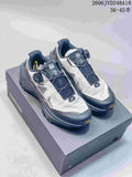 Pair of light-colored Kailas FUGA EX3 trail shoes with dark gray and navy details, shown on a shoebox.