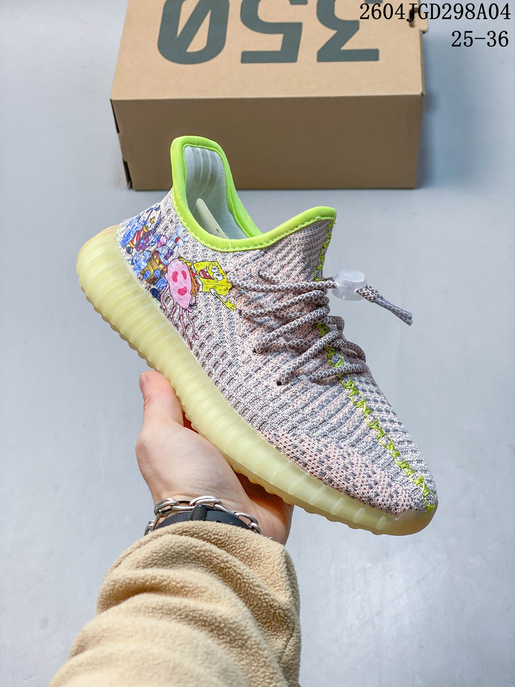 Angled side view of the sneaker showing cartoon graphics and bright lime-green collar trim.