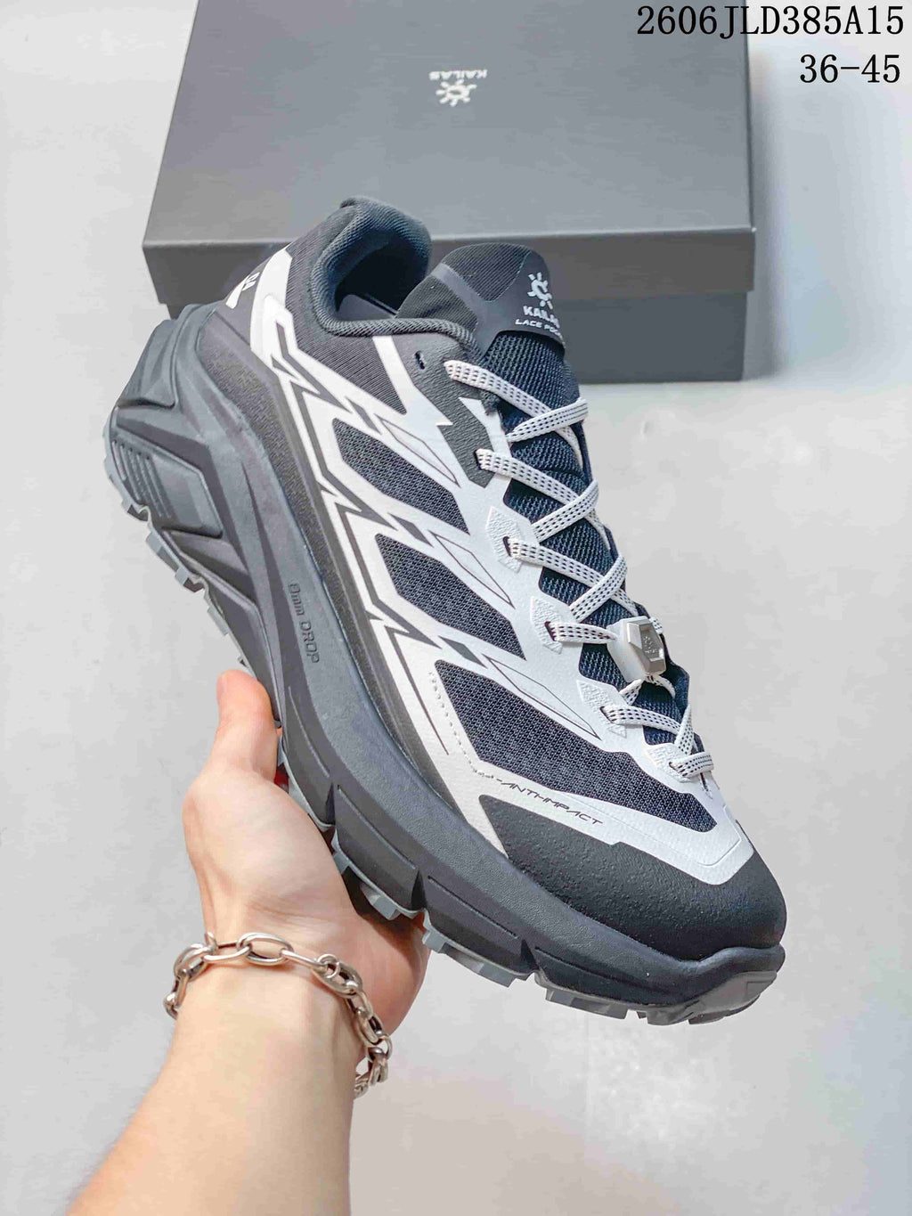 Gray and dark navy Kailas C4 trail running shoe shown from the side.
