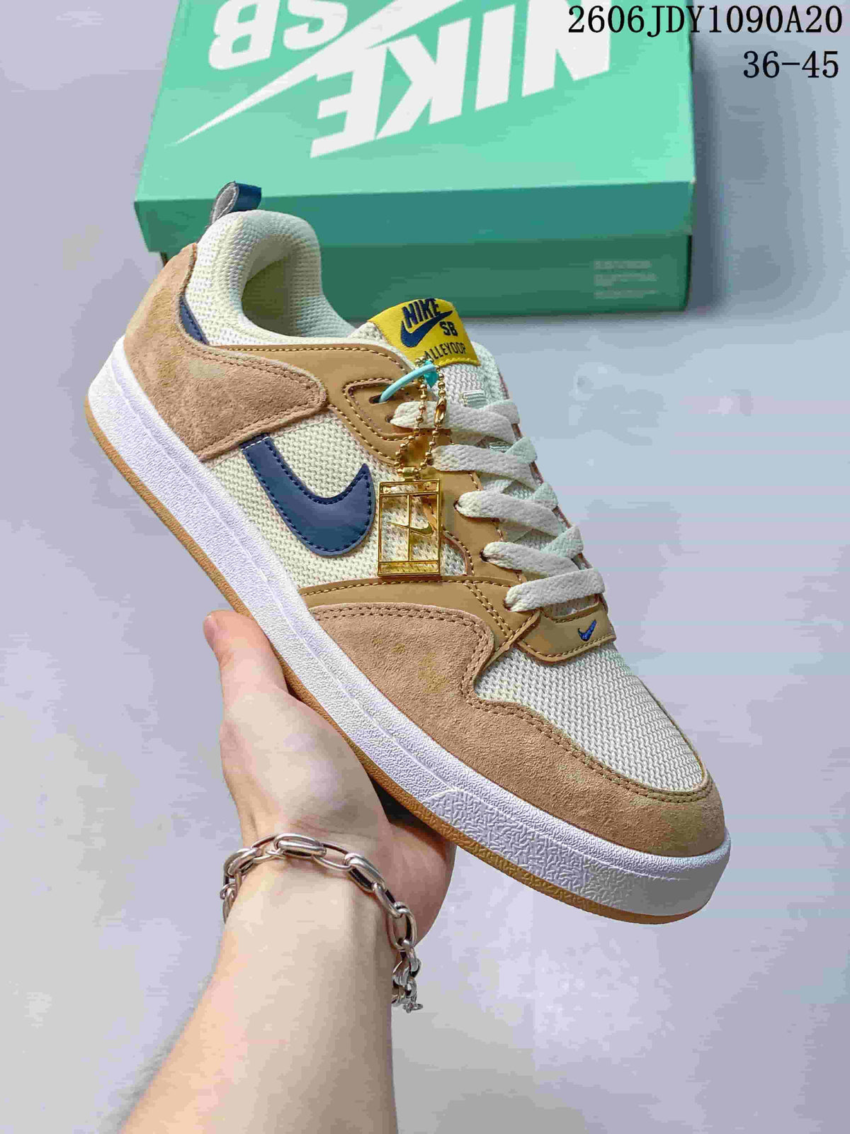 Nike SB Alleyoop low-top sneaker in cream and tan with a navy Swoosh