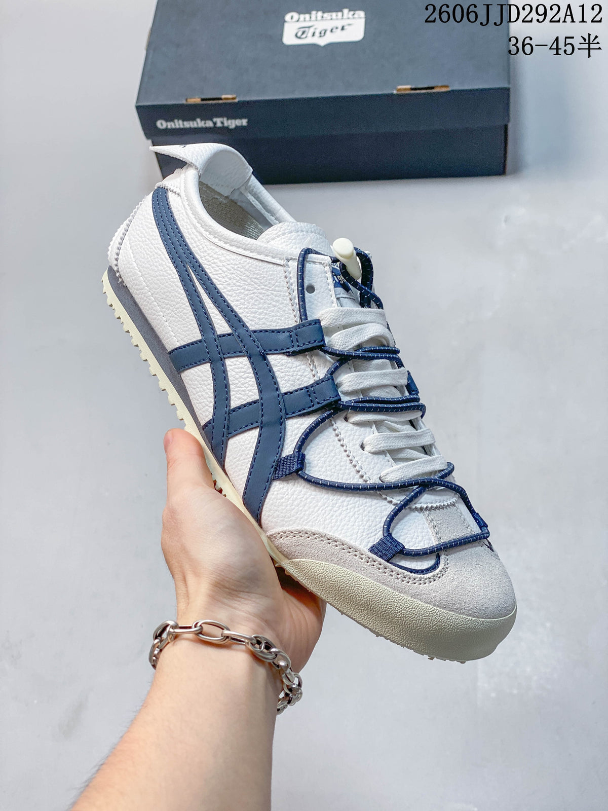 Side view of a white Onitsuka Tiger Mexico 66 Deluxe sneaker with blue accents and cord details.