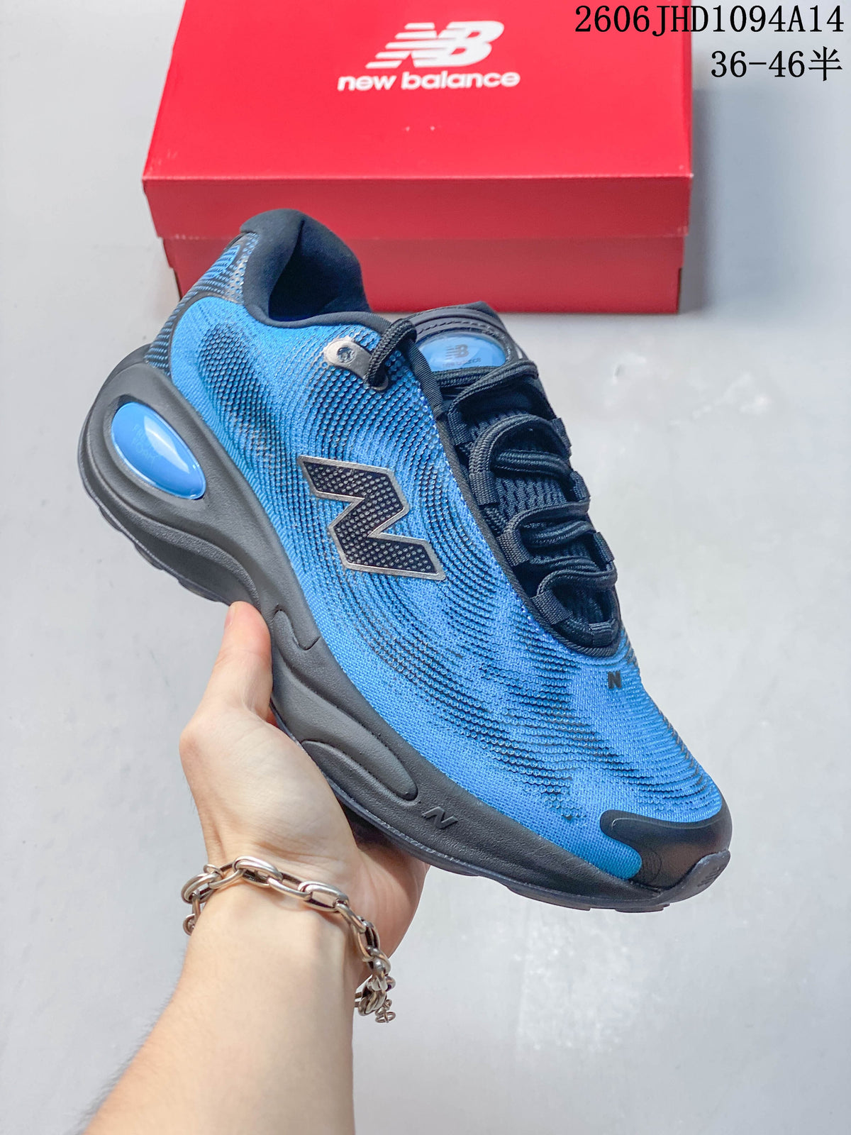 Angled side view of the blue and dark gray New Balance shoe