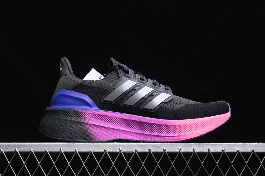 Side profile showing the black upper, gray stripes, and pink midsole