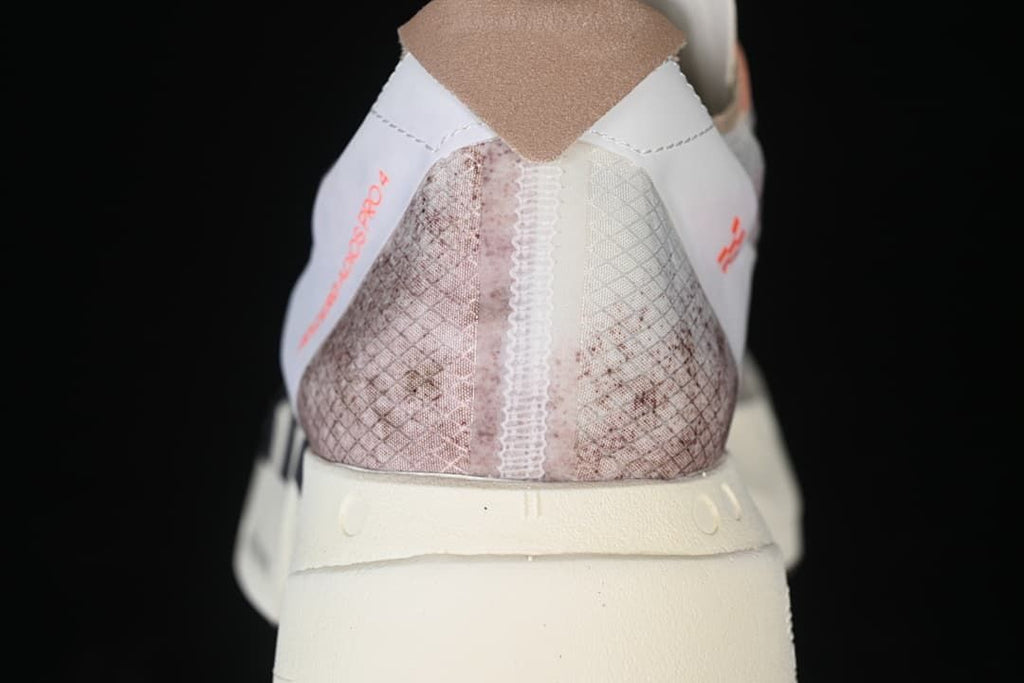 Rear view showing the patterned heel and cream-colored sole