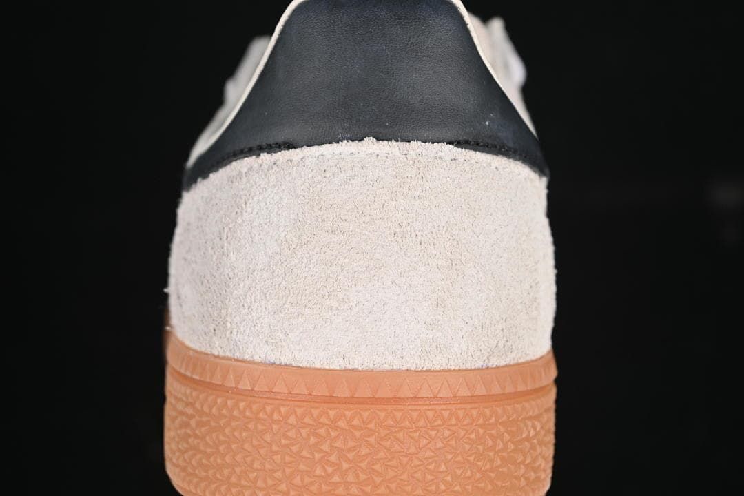 Rear view showing the light upper, black heel detail, and gum outsole