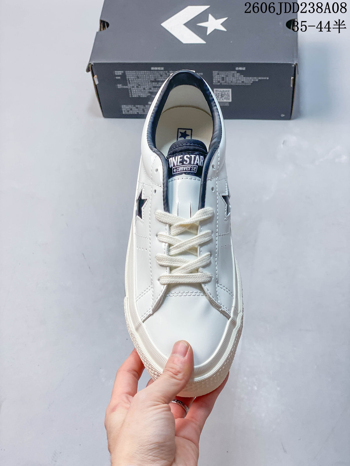 Top view of a white Converse One Star sneaker with cream-colored laces
