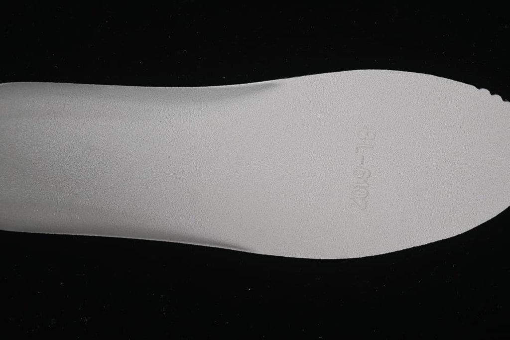 Close-up of the sneaker insole with faint embossed markings