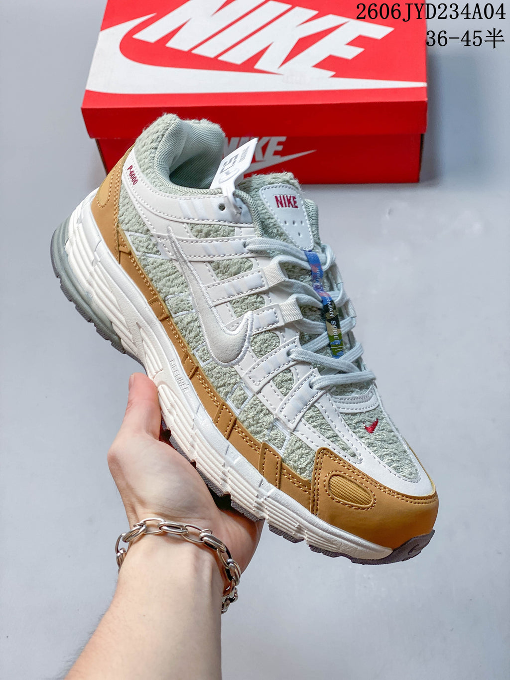 Angled side view of the Nike P-6000 in light green, white, and tan.