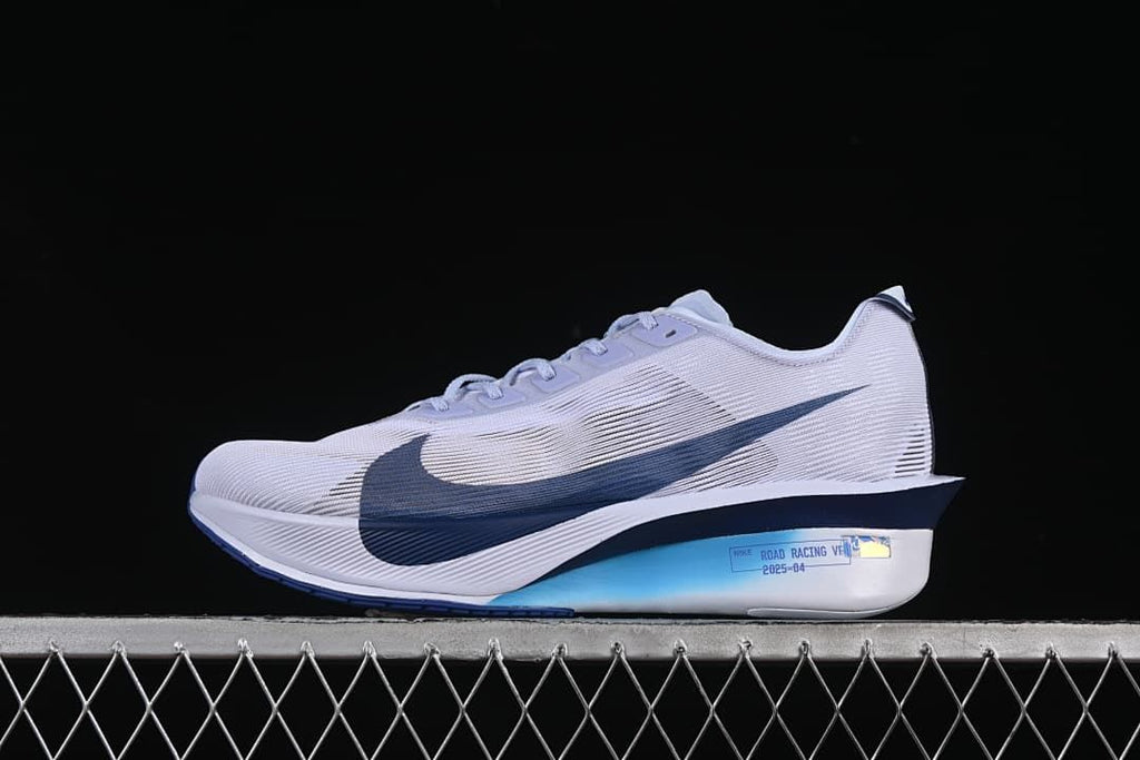 Side view of a light gray Nike ZoomX Vaporfly Next% 4 with dark blue Swoosh and accents