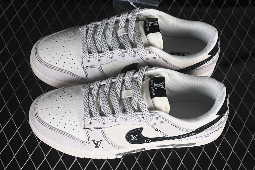 Overhead view of a pair of white and pale gray low-top sneakers with patterned laces and graphic side details