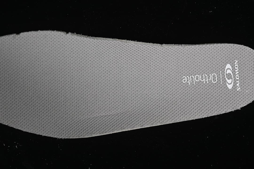 Close-up of a gray textured insole with Salomon and Ortholite markings