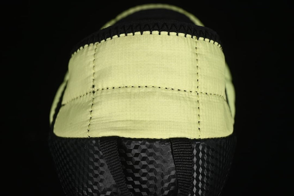 Rear view of the yellow quilted heel and black outsole.