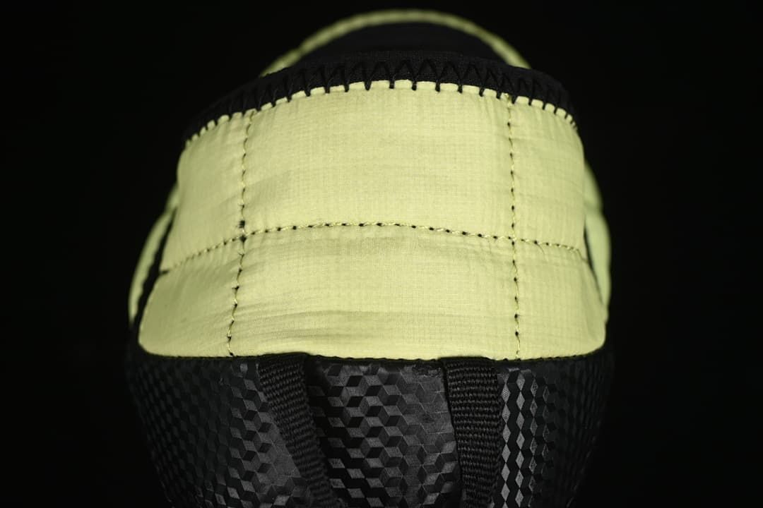Rear view of the yellow quilted heel and black outsole.
