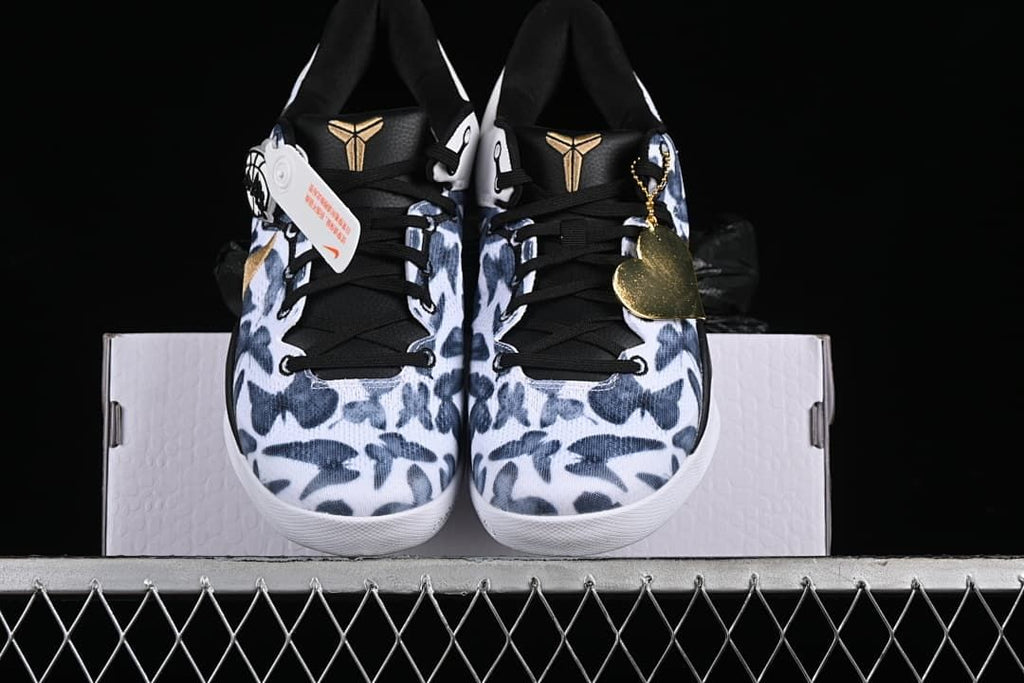 Front view of the pair showing patterned toes, black tongues, and gold Kobe logos.